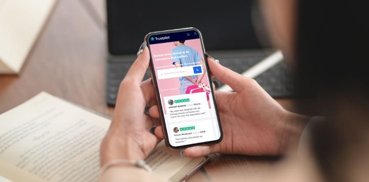 A phone checking customer reviews on Trustpilot