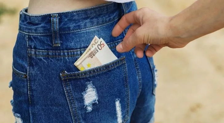 Pick Pocketer taking Euros out of woman's jeans