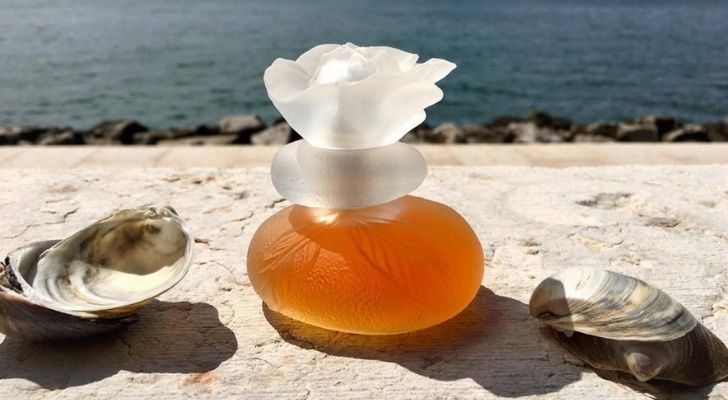 The stunning perfume bottle made of two pebbles onto of each other and a flower on top