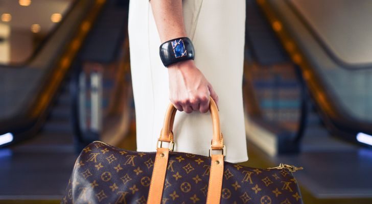 A person carrying a Louis Vuitton bag.