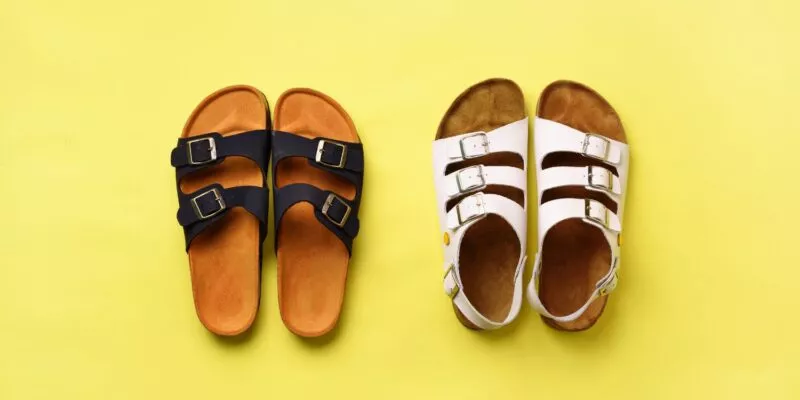 Two different pairs of Birkenstocks side by side on a yellow background